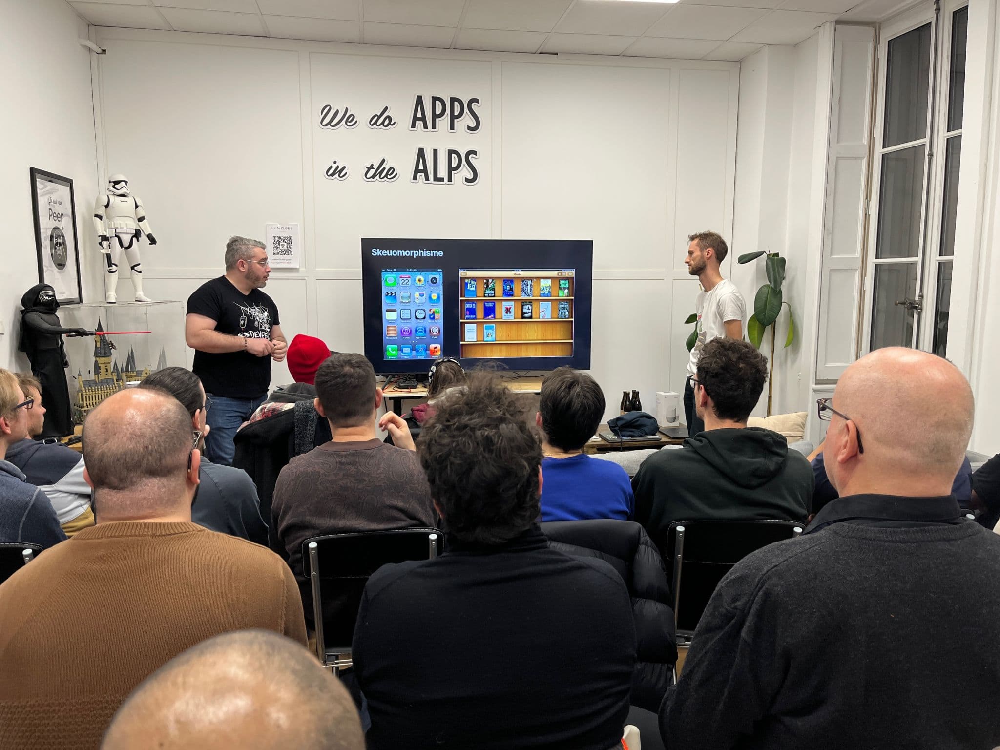 Antoine and Simon presenting at a developer meetup, facing the audience